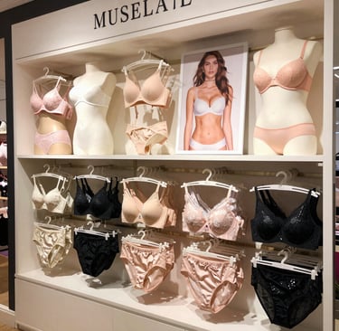 A cozy display of colorful lingerie sets arranged on a wooden table with soft natural light.