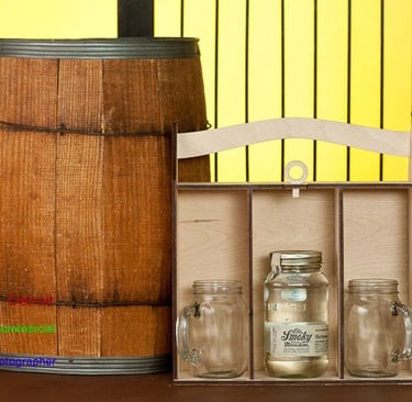 A scene depicting a wooden barrel and box with and a glass jars
