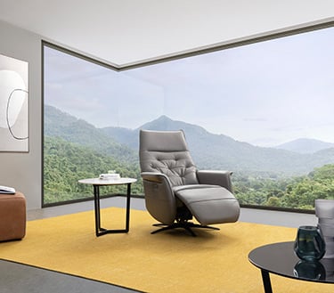 a living room with a large window and a view of the mountains