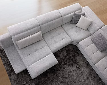 a couch with a large sectional couch and a rug