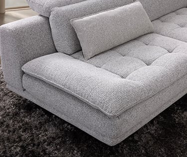 a couch with pillows and pillows on a rug