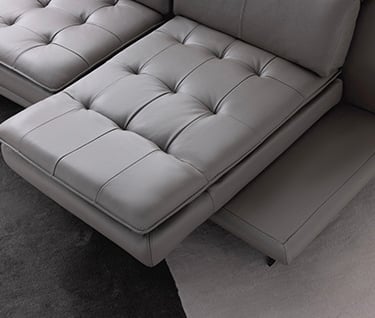 a couch with a large ottoman and a chair