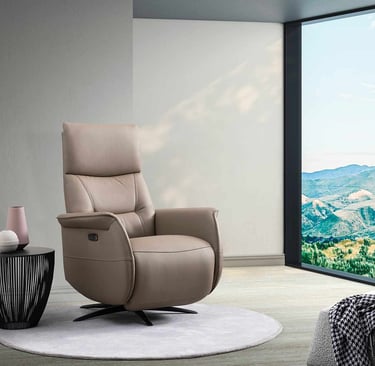 a chair with a large window and a view of a mountain