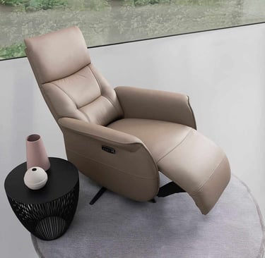 a reclining chair with a vase of flowers