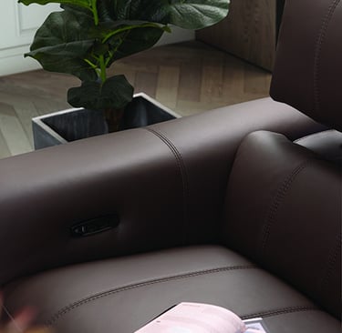 a book is sitting on a couch with a magazine