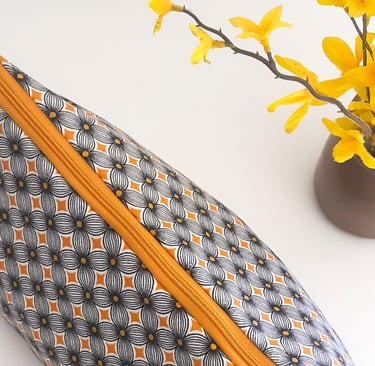 a small zippered pouchel bag with a yellow flower
