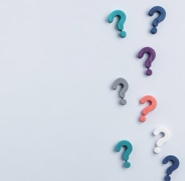 three question marks on a light gray background