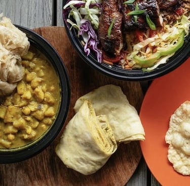 Buss up shut, curry goat with potato and channa. Also, doubles with Chinese style chicken.