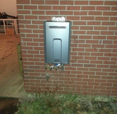 a tankless water heater on a brick wall