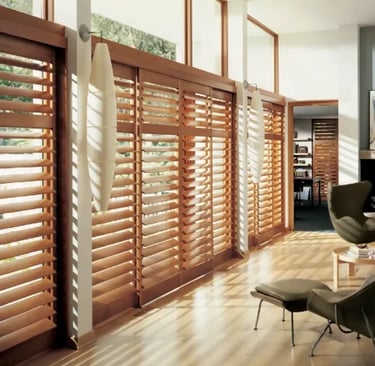 living room with large wood shutters filtering sunlight – Rise Up Window Coverings Milwaukee