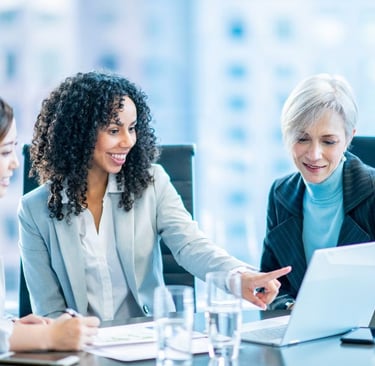 a group of business people sitting around a table