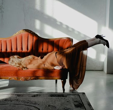 woman face down on orange couch
