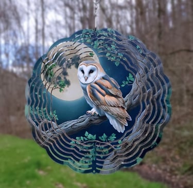 a wind spinner picturing an owl in the moonlight.
