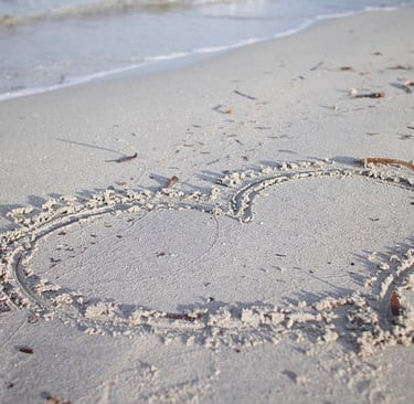 a shaped heart drawn in the sand