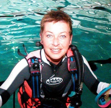 a woman in a diving suit and scuba gear
