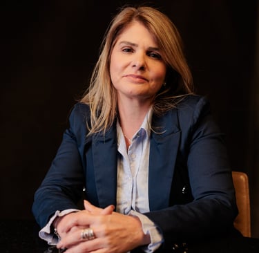 a woman in a suit and a ring on her finger