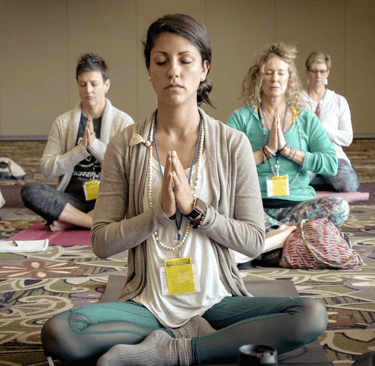 a woman in a yoga pose with her hands clasped together