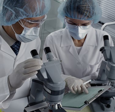 two people in lab coats and surgical masks