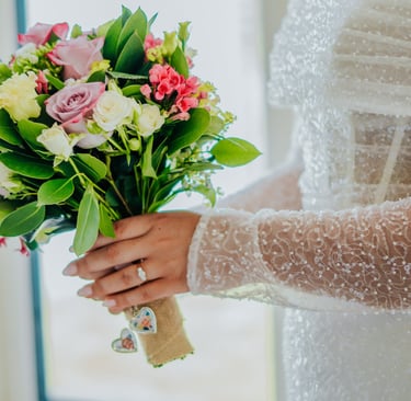 a bridesmaid holding a bouquet of flowers