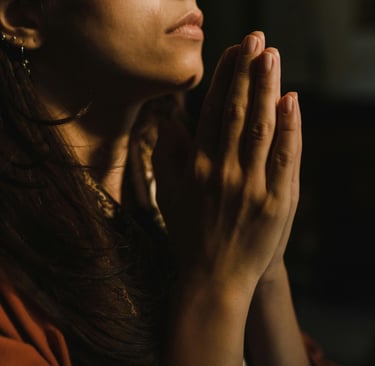 a woman in a red shirt is praying