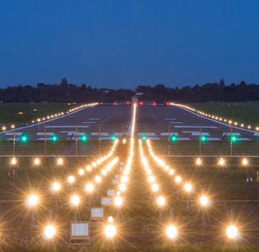 a runway at night with a runway and traffic lights