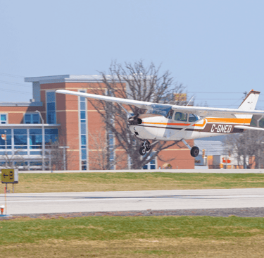 a small plane taking off from a runway