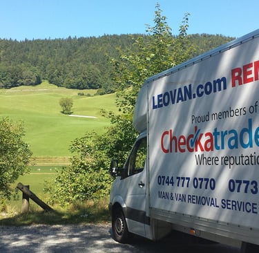 a truck with leovan.com sign parked in nature