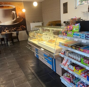 a coffee shop with a large cup of coffee and a cup of coffee
