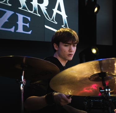 a man playing drums in a band