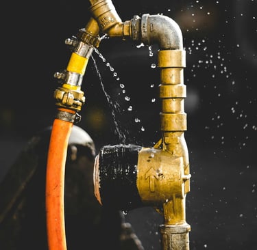 a hose faucet with water coming out of it