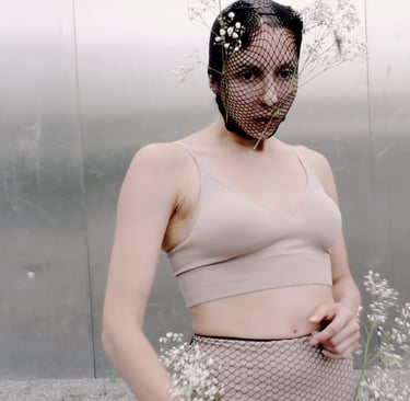 Performer standing in front of textured wall – Lingua Materna film still by Tina Bikic
