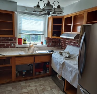 a kitchen with drop colthes on conter top