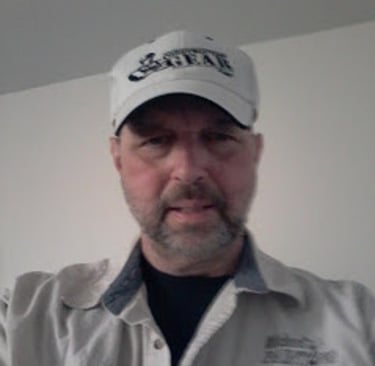 a man in a white shirt and a white hat