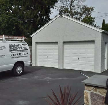 a van in the driveway and a garage