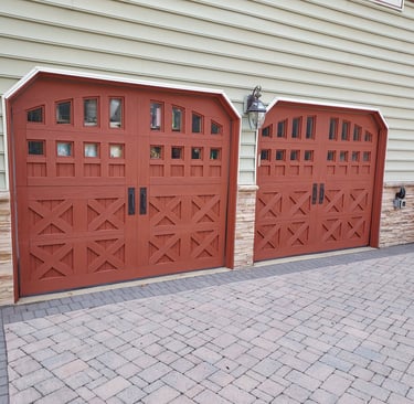  a drive way with 2 painted garage doors