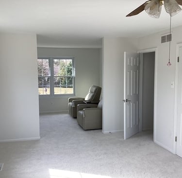 a finished painted bedroom wit chairs