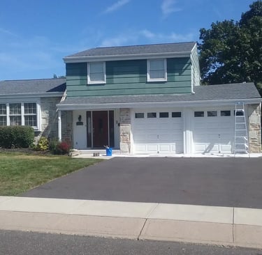 a house with a driveway and ladders 
