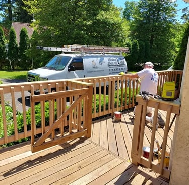 a man painting a deck deck