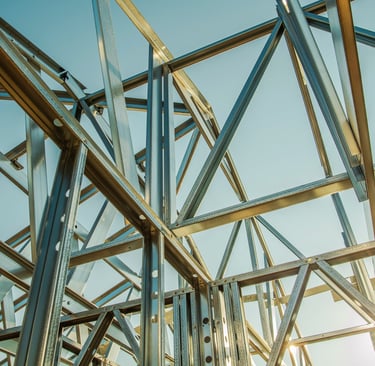 a metal structure with a sky view of a building