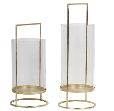 a pair of glass candle holders lantern with a gold metal frame