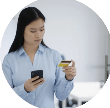 Women holding her mobile phone while looking at her bank card