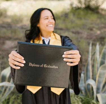 a woman in a graduation gown holding a diploma certificate