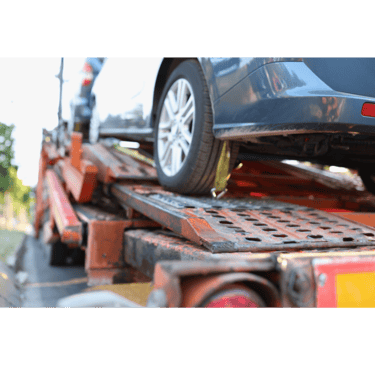 Small sedan loaded on a flatbed tow truck after being stranded on I-15.