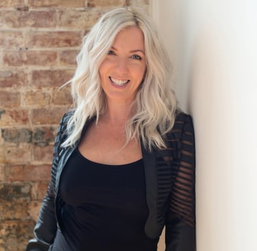 Headshot of artist and photographer Tanya Smith of Sweet Ruby Moon on brick wall