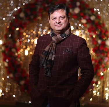 a man in a suit and tie with a scarf around his neck