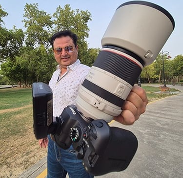 a man holding a camera and a camera