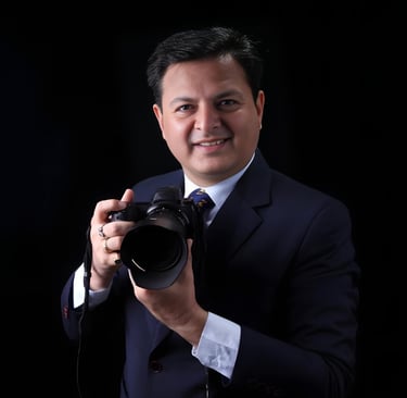 a man in a suit and tie is holding a camera
