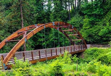 Portland, OR - Walk across the footbridge to see a small waterfall at Hidden Falls Park