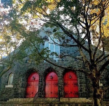 Portland, OR - An old stone church with 3 bright red doors in downtown 