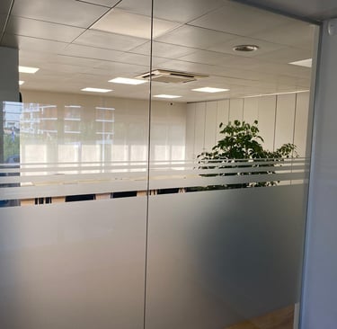 a glass door with a plant in the middle